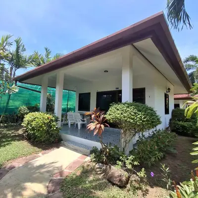 a house with a view of the ocean at D&K Smiley Phuket Resort in Rawai Beach