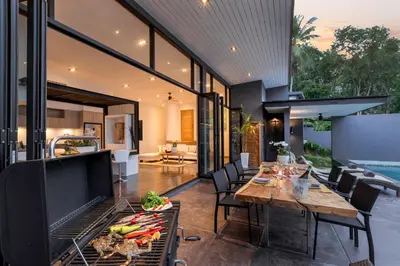 a kitchen and dining room with a table and chairs at Braya Villa in Ko Yao Yai