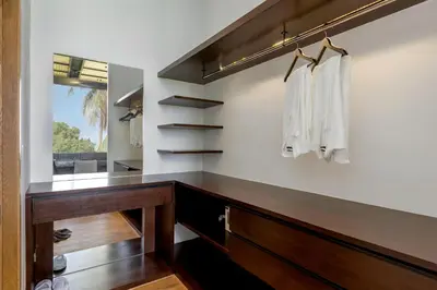 a dressing room with a wooden desk and a mirror at Braya Villa in Ko Yao Yai