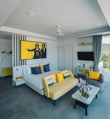 a living room with a large bed and a couch at Villa Enjoy Phuket in Patong Beach