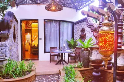 a patio with a table and chairs in a house at Sawasdee Village in Kata Beach