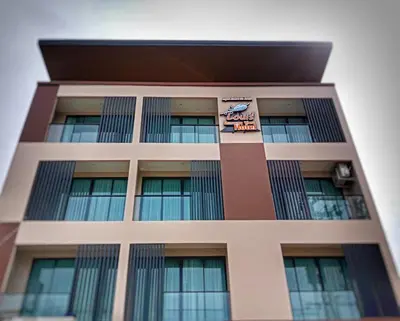 a tall building with a sign on it at Louis' Runway View Hotel - SHA Extra Plus in Nai Yang Beach