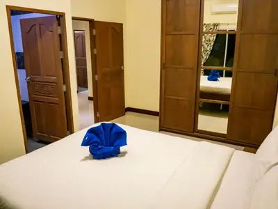 a bedroom with a bed with a blue backpack on it at Villa Tanya, 3 Bed with Private Pool and Jacuzzi in Rawai Beach