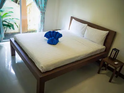 a bed with a blue flower on top of it at Villa Tanya, 3 Bed with Private Pool and Jacuzzi in Rawai Beach
