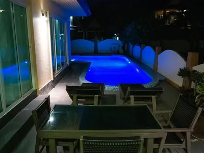 a swimming pool at night with a table and chairs at Villa Tanya, 3 Bed with Private Pool and Jacuzzi in Rawai Beach