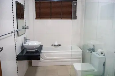 a bathroom with a tub and a sink and a toilet at Villa Tanya, 3 Bed with Private Pool and Jacuzzi in Rawai Beach