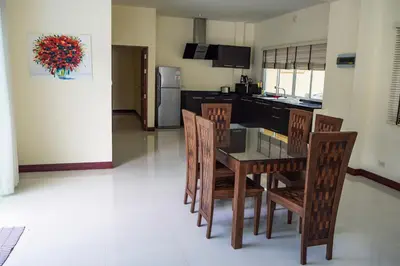 a kitchen and dining room with a table and chairs at Villa Tanya, 3 Bed with Private Pool and Jacuzzi in Rawai Beach