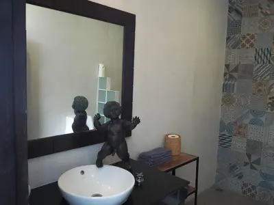 a bathroom with a statue on a sink in front of a mirror at Spacious 4 Bedrooms Private Pool Villa in Phuket in Rawai Beach