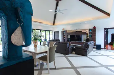 a living room with a table and chairs at Spacious 4 Bedrooms Private Pool Villa in Phuket in Rawai Beach