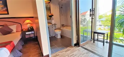 a bedroom with a bathroom with a tub and a toilet at La Moon At Phuket - SHA Extra Plus in Phuket Town