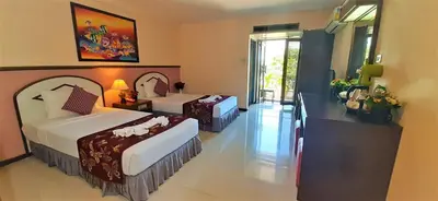 a hotel room with two beds and a balcony at La Moon At Phuket - SHA Extra Plus in Phuket Town