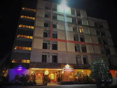 a building with a christmas tree in front of it at La Moon At Phuket - SHA Extra Plus in Phuket Town