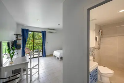 a bathroom with a sink and a toilet in a room at Maikhao Hotel, Phuket in Mai Khao Beach