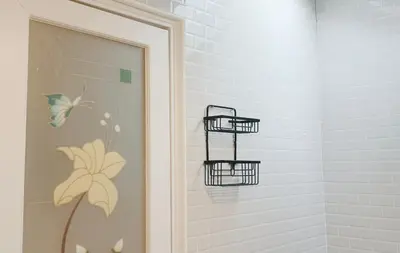 a bathroom with two baskets on the wall at Nua Tone Resort Bang Tao & Cafe in Bang Tao Beach