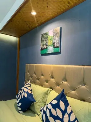 a couch with pillows on it in a room at Resting Place Ko Yao Yai in Ko Yao Yai
