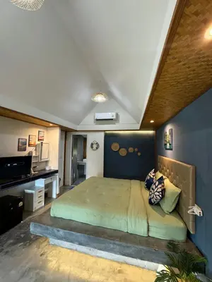 a bedroom with a large bed with a blue wall at Resting Place Ko Yao Yai in Ko Yao Yai