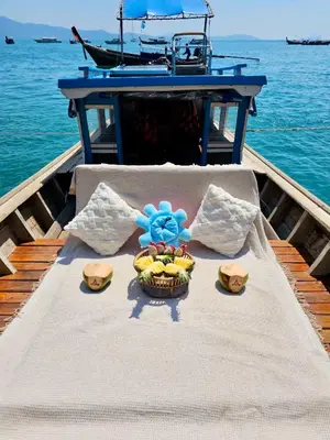 a table with a bowl of fruit on a boat at Baan Taranya Koh Yao Yai Resort in Ko Yao Yai