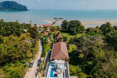 an aerial view of a house with a pool and a windmill at Baan Taranya Koh Yao Yai Resort in Ko Yao Yai