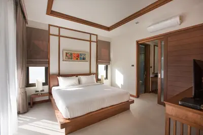 a bedroom with a white bed and a television at Villa Palavee (A2) in Ao Nang Beach