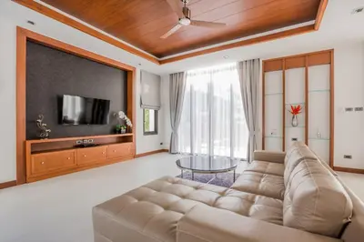 a living room with a couch and a flat screen tv at Villa Palavee (A2) in Ao Nang Beach