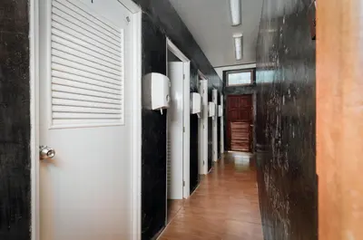 a hallway with black walls and a white door at Ibiza House Phi Phi in Phi Phi Don