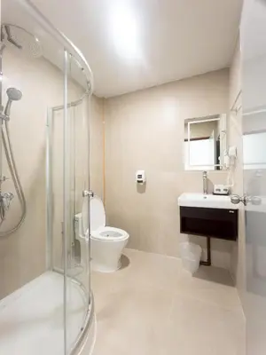 a bathroom with a shower and a toilet and a sink at Ibiza House Phi Phi in Phi Phi Don