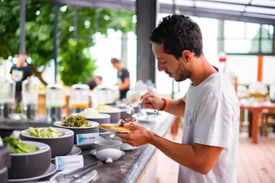 a man eating a plate of food at a buffet at Ibiza House Phi Phi in Phi Phi Don