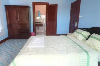 a bedroom with a large white bed in a room at Majestic Villas Guesthouse Phuket. in Rawai Beach