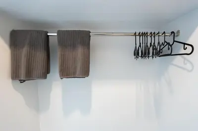 two towels hanging on a towel rack in a bathroom at Minimal House Patong in Patong Beach