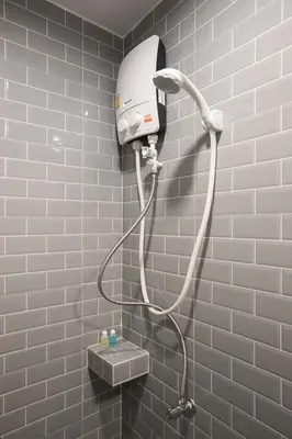 a shower in a bathroom with a hair dryer at Minimal House Patong in Patong Beach