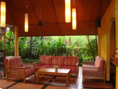 a patio with two couches and a table at Palm Garden Resort in Rawai Beach