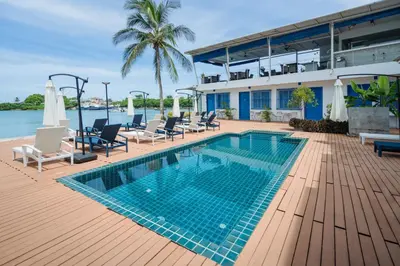 a swimming pool on the deck of a resort at Phuket Boat Quay Hotel Panwa Beach in Panwa Beach