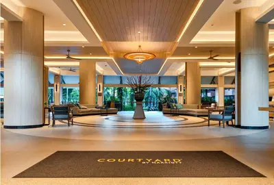 a lobby of a hotel with couches and a rug at Courtyard by Marriott Phuket, Patong Beach Resort in Patong Beach