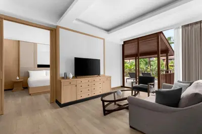 a living room with a television and a bedroom at Courtyard by Marriott Phuket, Patong Beach Resort in Patong Beach