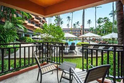a balcony with chairs and tables and a pool at Courtyard by Marriott Phuket, Patong Beach Resort in Patong Beach