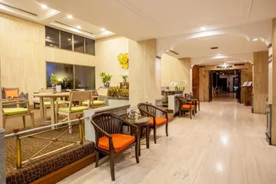 a lobby of a hotel with tables and chairs at Phuket Merlin Hotel in Phuket Town
