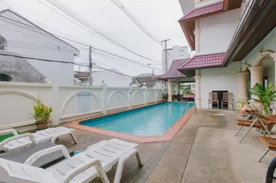 a swimming pool in the middle of a building at Royal Prince Residence, Patong Beach in Patong Beach