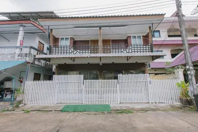 a white fence in front of a house at Royal Prince Residence, Patong Beach in Patong Beach