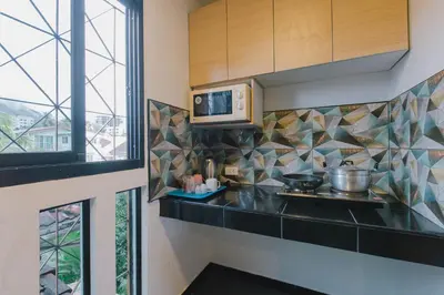 a kitchen with a counter top and a microwave at Royal Prince Residence, Patong Beach in Patong Beach