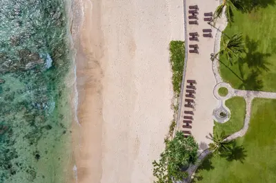 an aerial view of a beach with a row of resorts at Phuket Marriott Resort & Spa, Merlin Beach in Patong Beach
