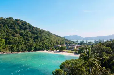 a beach in the middle of acean with trees at Phuket Marriott Resort & Spa, Merlin Beach in Patong Beach