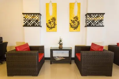 a waiting room with two wicker chairs and a table at EX-IT Inn in Patong Beach