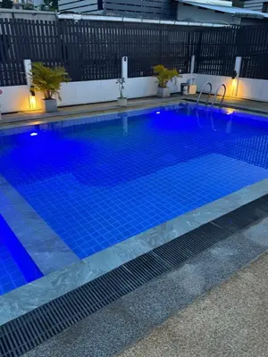 a large swimming pool with blue water at EX-IT Inn in Patong Beach
