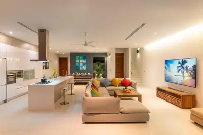 a large living room with a couch and a kitchen at Luxurious SeaView 4br Private Pool Villa by Intira Villas in Rawai Beach