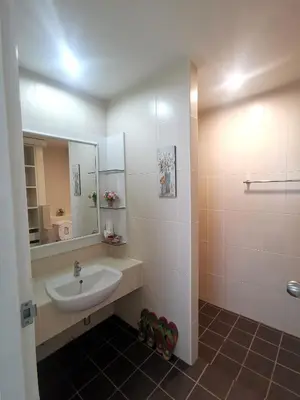 a bathroom with a sink and a mirror at Phuket Racha Kata Homestay in Kata Beach