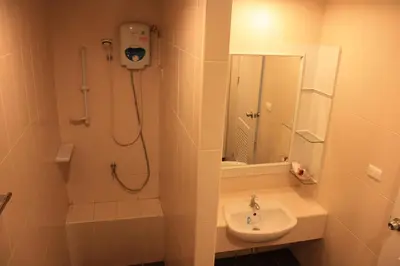 a bathroom with a shower and a sink at Phuket Racha Kata Homestay in Kata Beach