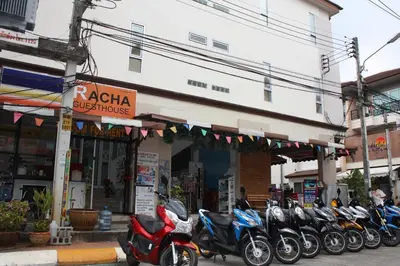 a row of motorcycles parked in front of a building at Phuket Racha Kata Homestay in Kata Beach