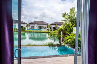 a view of a swimming pool from a window at Villa Bang Tao 3 Bedroom Q Kata Residence in Bang Tao Beach