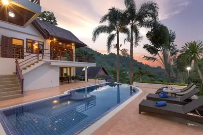 a house with a swimming pool in front of a house at Patong Hill Estate 6 in Patong Beach