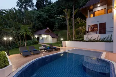 a villa with a swimming pool and a house at Patong Hill Estate 6 in Patong Beach